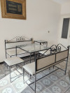 Ensemble: 2 tables 2 banquettes 2 bancs fer forgé, tissus beige et vitres