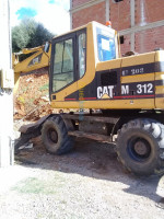 location-de-vehicules-pelle-caterpillar-m312-amira-arras-mila-algerie