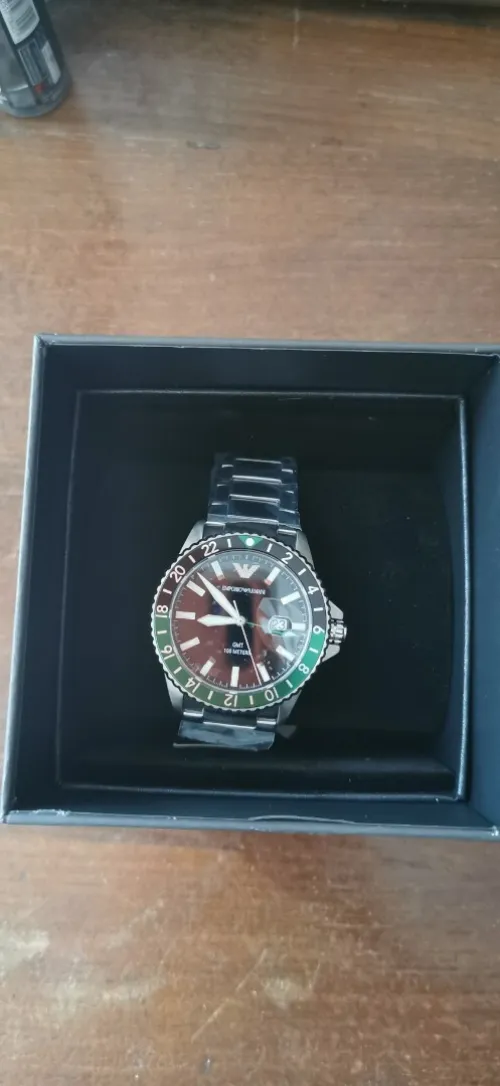 Emporio Armani World Explorer watch (AR11589) features a distinctive green and black "Sprite" GMT bezel
