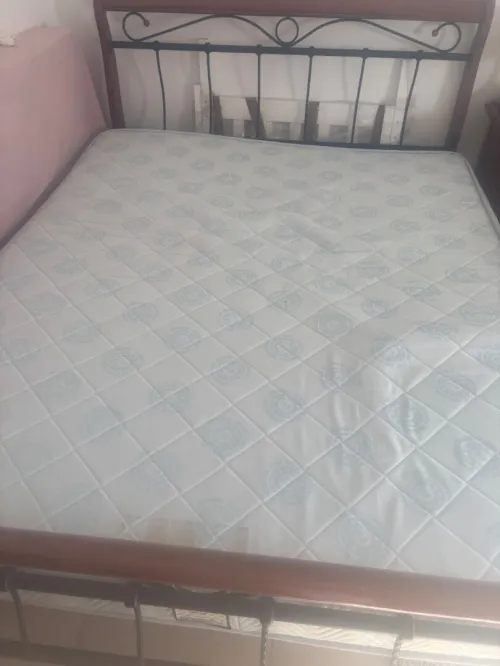 Un lit double avec matelas orthopédique